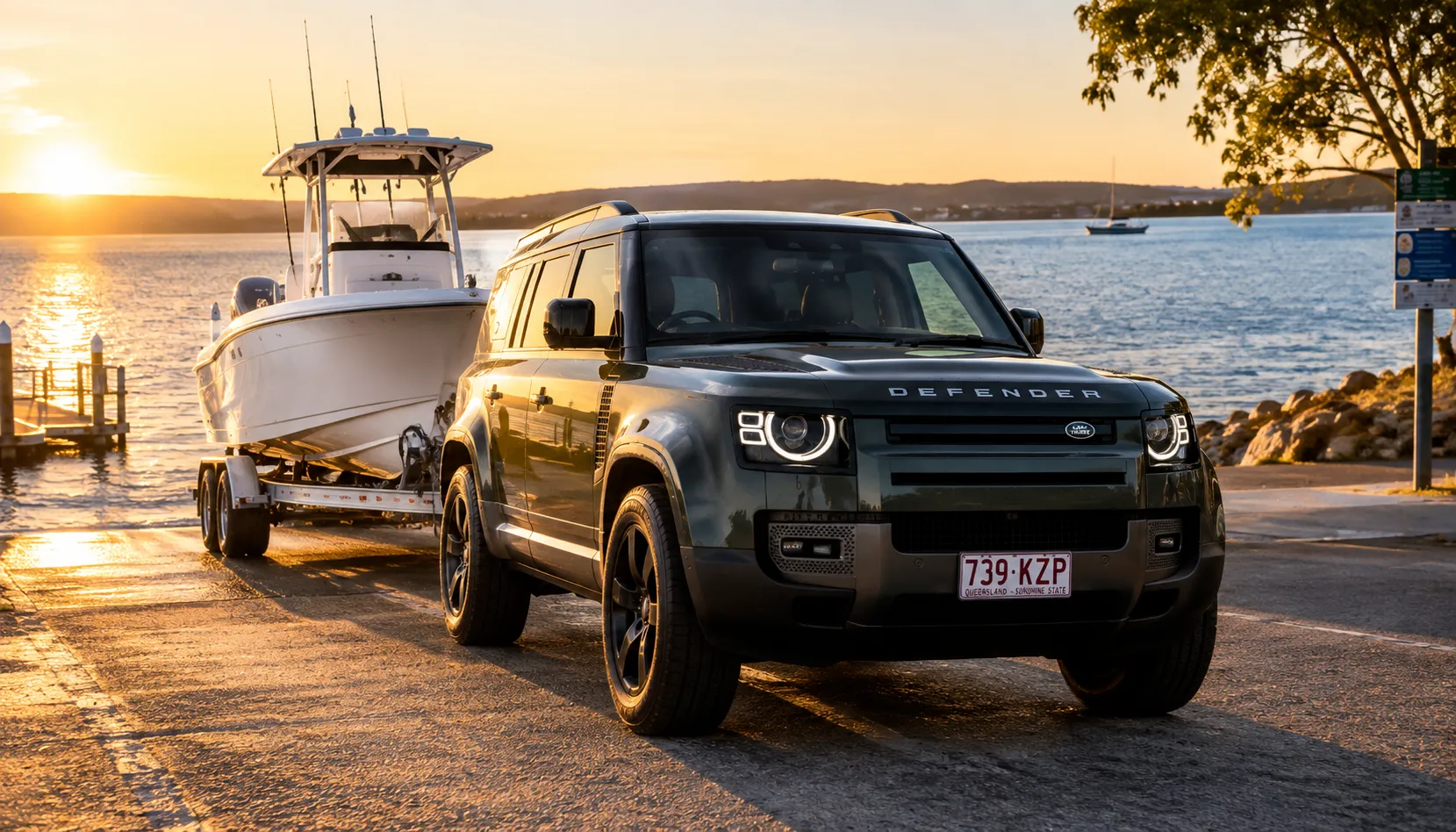 Retire From Boat Ramp Theatre Land Rover Defender towing a boat from a Queensland ramp after Advanced Tow Assist activation