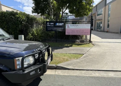 Street frontage of 128 Steel Street Capalaba with a Land Rover Discovery parked at the kerb and the SemCar and Euro-Aus sign on the fence