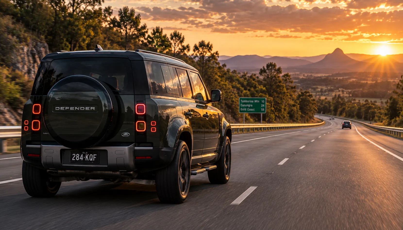 Which Path Is Yours Land Rover Defender with adaptive cruise control on a Queensland highway at sunset
