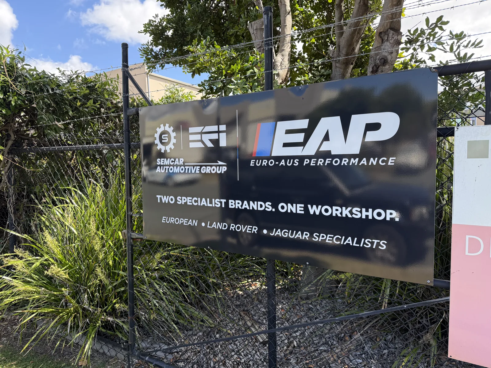 SemCar and Euro-Aus fence sign Close-up of the SemCar and Euro-Aus Performance fence sign at the 128 Steel Street driveway