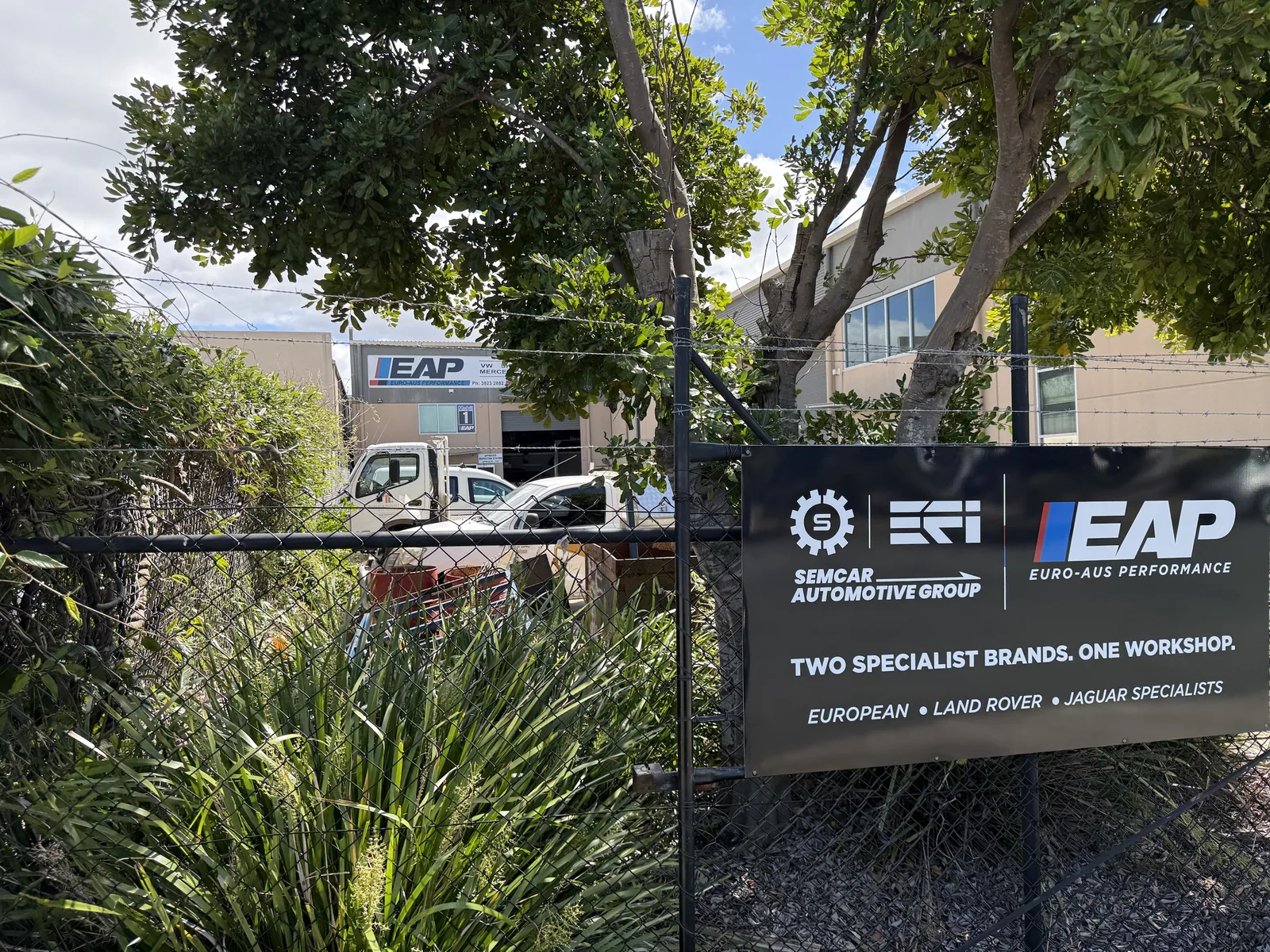 The black SemCar and Euro-Aus Performance sign on the fence at 128 Steel Street Capalaba marks the driveway