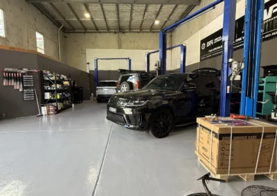 Range Rover Sport on the hoist inside SemCar's Unit 2 workshop, 128 Steel Street Capalaba
