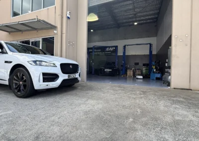 Jaguar F-Pace outside SemCar's open Unit 2 workshop bay at 128 Steel Street Capalaba